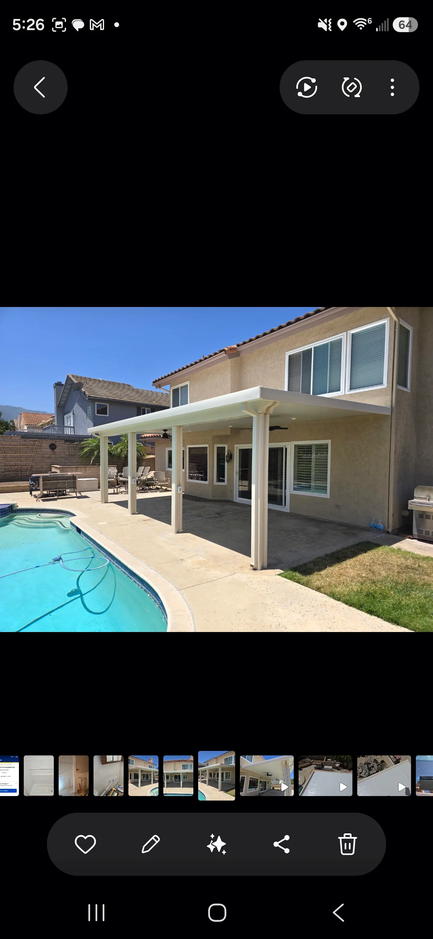 White aluminum patio cover with posts and beam over concrete patio near swimming pool
